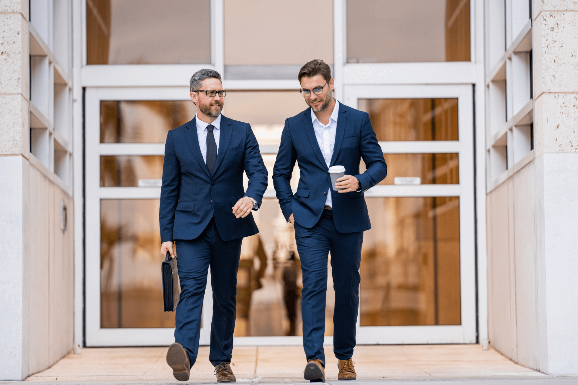 Business men walking out of a building